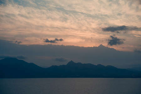 Beautiful natural landscape with mountains, sea and cloudy skyの写真素材