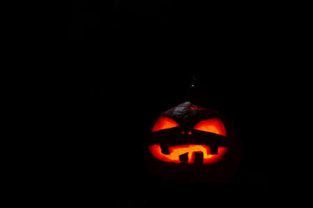 Pumpkin with burning mouths and eyes on blank black background. Jack-o-lantern decoration.の写真素材
