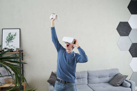 Man with virtual reality headset is playing game.の写真素材