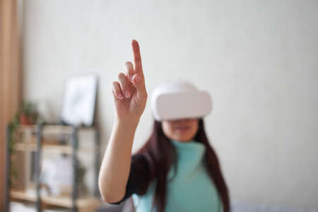 Woman is using virtual reality headset. Concept of virtual reality, gaming and future technology.