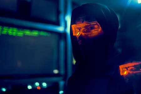 Cyber hacker breaks into databases to obtain information using a computer.