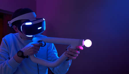 Man with virtual reality headset and joystic is playing gameの写真素材