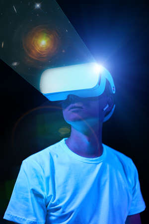 Man uses virtual reality headset to see the far corners of space.の写真素材