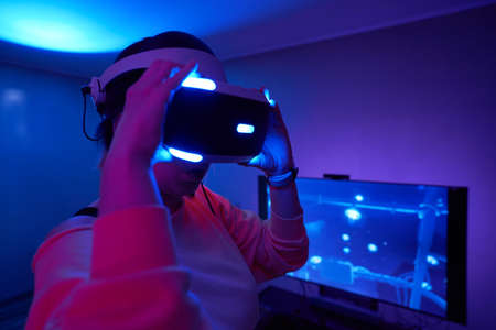 Woman interacts with virtual reality using a vr headset.