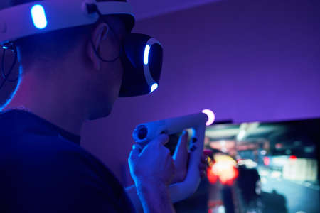 Man with virtual reality headset and joystic is playing gameの写真素材