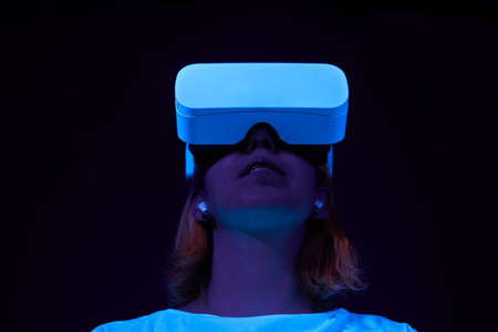 Woman interting with virtual reality using vr headset.の写真素材