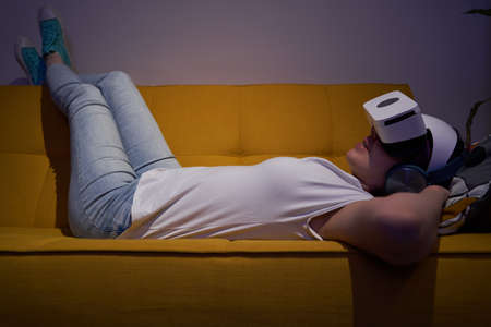 Woman interacts with virtual reality using a vr headset.の写真素材
