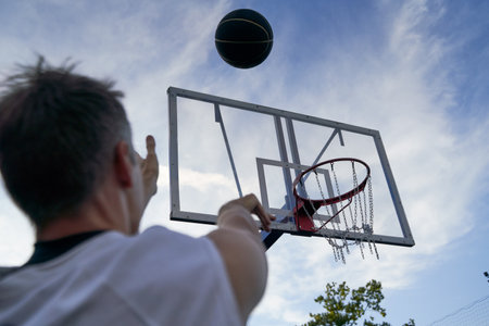 Man is throwing ball to the hoop. Training of basketballの写真素材