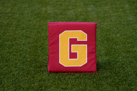 Close-up detail of a yard marker standing on a soccer field.