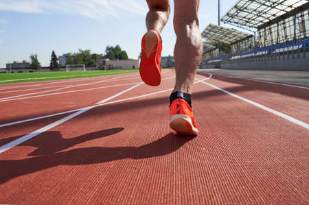 Athlete runner feet running on treadmill closeup on shoe