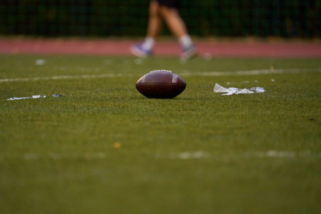 Ball for american football on green grassの写真素材