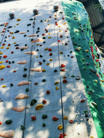 Artificial rock climbing bouldering wall showing various colored grips.の写真素材