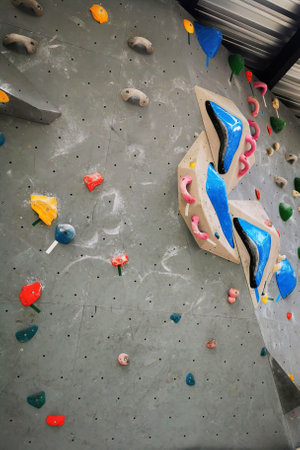 Artificial rock climbing bouldering wall showing various colored grips.の写真素材