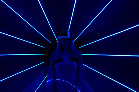 Woman is using virtual reality headset to access in metaverse.の写真素材