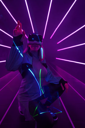 Woman is using virtual reality headset to access in metaverse.の写真素材