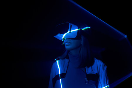 Woman is using virtual reality headset to access in metaverse.の写真素材