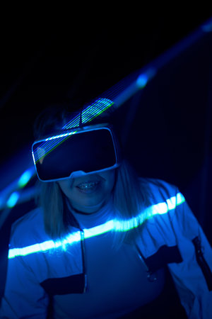 Woman is using virtual reality headset to access in metaverse.の写真素材