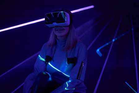 Woman is using virtual reality headset to access in metaverse.の写真素材