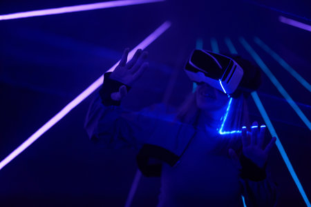 Woman is using virtual reality headset to access in metaverse.の写真素材