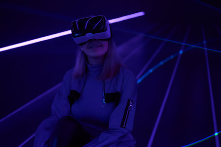 Woman is using virtual reality headset to access in metaverse.の写真素材