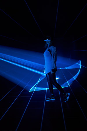 Woman is using virtual reality headset to access in metaverse.の写真素材