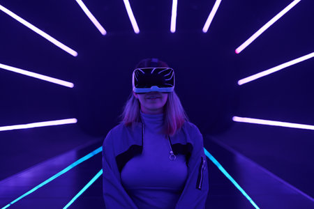Woman is using virtual reality headset to access in metaverse.の写真素材