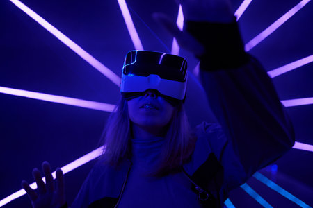 Woman is using virtual reality headset to access in metaverse.の写真素材