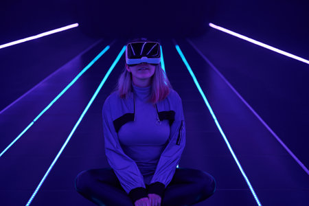 Woman is using virtual reality headset to access in metaverse.の写真素材