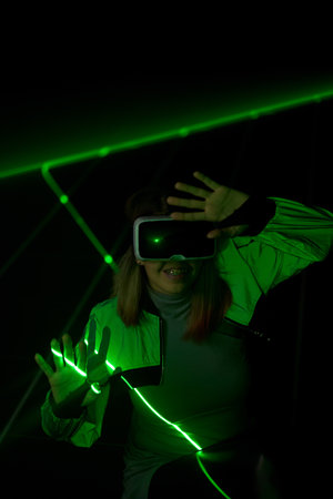 Woman is using virtual reality headset to access in metaverse.の写真素材