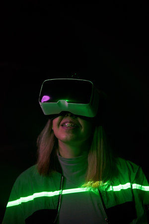 Woman is using virtual reality headset to access in metaverse.