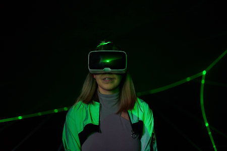 Woman is using virtual reality headset to access in metaverse.の写真素材