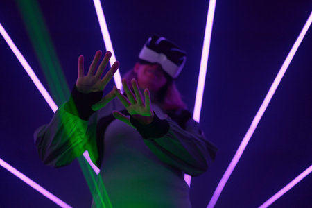 Woman is using virtual reality headset to access in metaverse.の写真素材