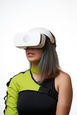 Woman is using virtual reality headset. Concept of virtual, augmented and extended reality and...