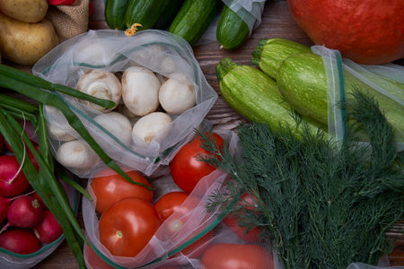 Healthy food vegetables in Eco-friendly packaging reusable bag on wooden table background.の写真素材