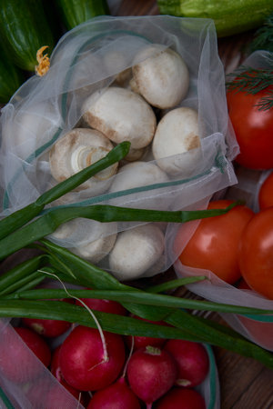 Healthy food vegetables in Eco-friendly packaging reusable bag on wooden table background.の写真素材