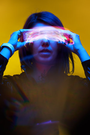 Woman is using augmented reality headset. Concept of virtual, augmented and extended reality.の写真素材