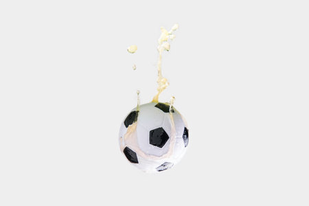 Soccer ball in beer splash on white background.の写真素材