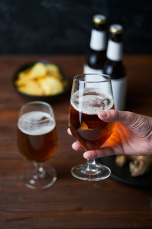Two glasses with beer, snacks and bottlesの写真素材