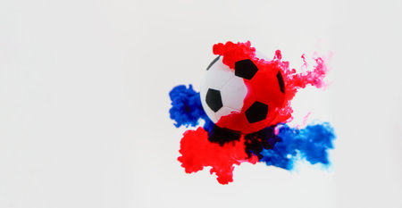 Soccer ball with red and blue color splash on white background.の写真素材