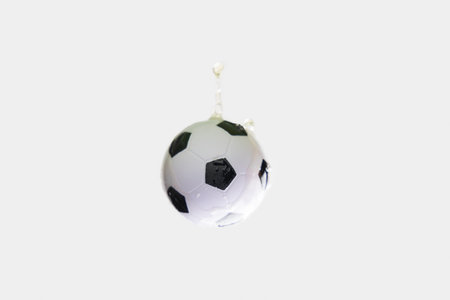 Soccer ball in beer splash on white background.の写真素材
