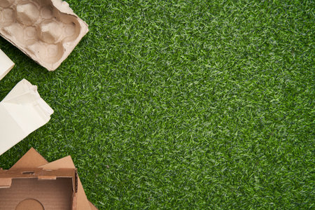 Paper collected for recycling on green grass background.の写真素材