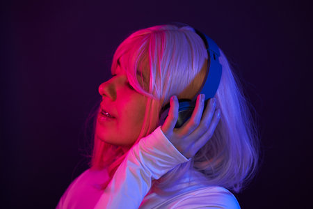 Woman in headphones listening music and enjoingの写真素材