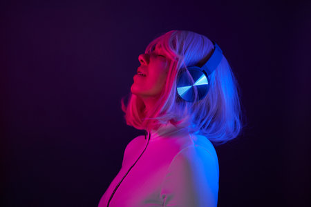 Woman in headphones listening music and enjoingの写真素材
