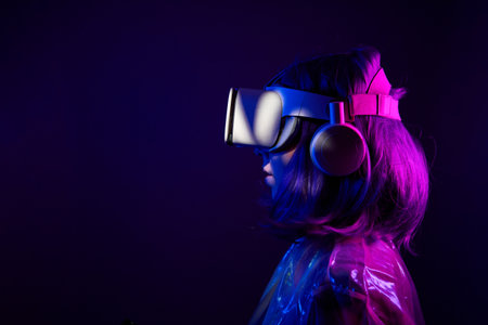 Woman in virtual reality goggle in neon colors.の写真素材