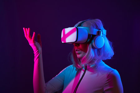 Woman in virtual reality goggle in neon colors.の写真素材
