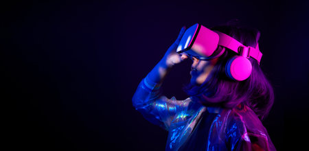 Woman in virtual reality goggle in neon colors.の写真素材