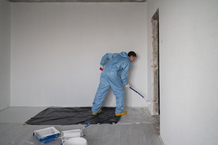 Man paints the ceiling with a rollerの写真素材