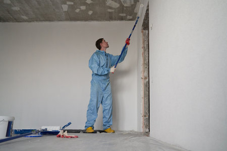Man paints the ceiling with a rollerの写真素材