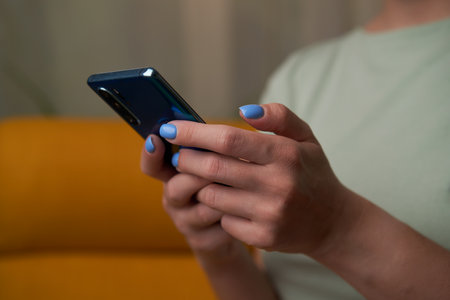 Woman is using smartphone, writing a message, browsing social networks.の写真素材