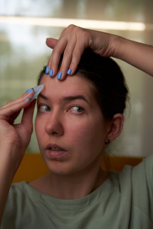 Woman is massaging her face scraper gua sha.の写真素材